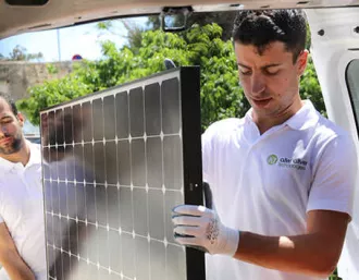 sunpower installers carrying sunpower solar panel