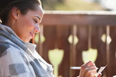 woman smiling and relaxing at her home