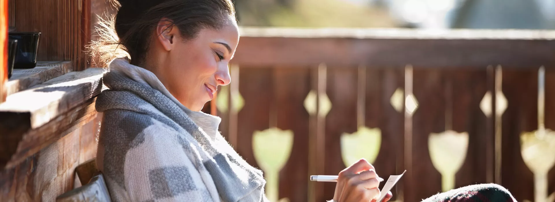 woman smiling and relaxing at her home