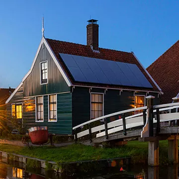 house next to canal with solar panels house next to canal with solar panels
