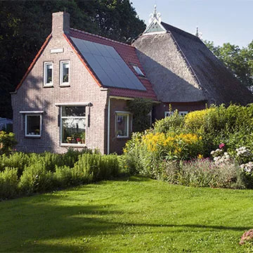 house with solar panels and thatched roof house with solar panels and thatched roof